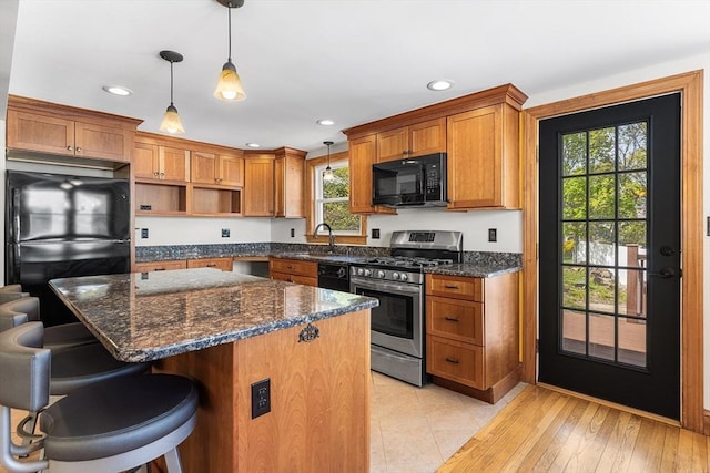 kitchen featuring brown cabinets, recessed lighting, open shelves, and black appliances