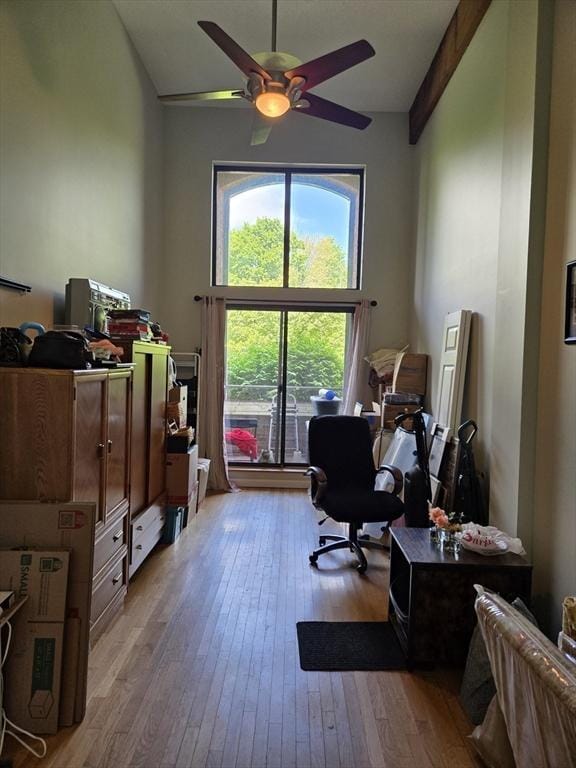 office area featuring lofted ceiling, wood-type flooring, and ceiling fan