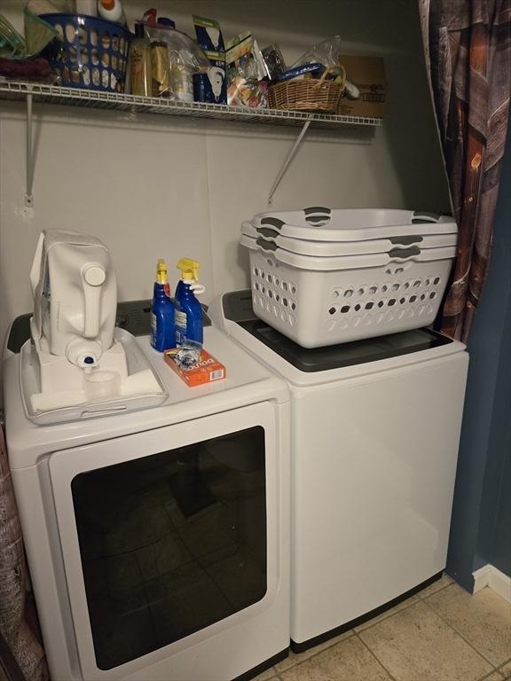 laundry area featuring separate washer and dryer and baseboards