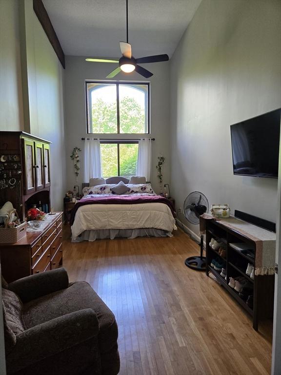 bedroom featuring hardwood / wood-style flooring and a ceiling fan