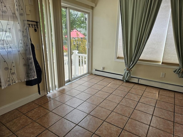 16 Boyd Ave, East Providence, RI 02914 - tiled empty room with a baseboard heating unit and baseboards