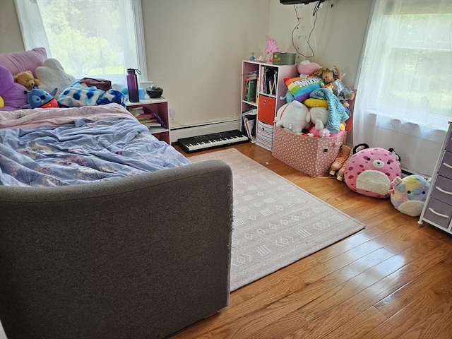 16 Boyd Ave, East Providence, RI 02914 - bedroom featuring multiple windows, baseboard heating, and wood finished floors