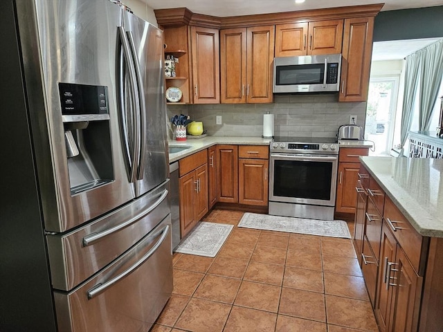16 Boyd Ave, East Providence, RI 02914 - kitchen featuring stainless steel appliances, brown cabinetry, decorative backsplash, open shelves, and light stone countertops