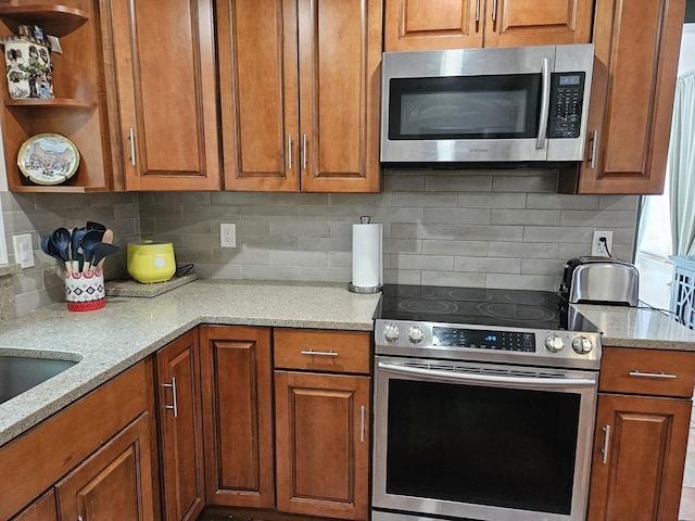 16 Boyd Ave, East Providence, RI 02914 - kitchen featuring appliances with stainless steel finishes, open shelves, and brown cabinetry