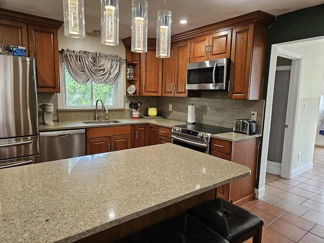16 Boyd Ave, East Providence, RI 02914 - kitchen featuring stainless steel appliances, a sink, brown cabinets, decorative backsplash, and recessed lighting