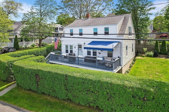 134 Hampton Cir, Hull, MA 02045 - back of house featuring a chimney, a yard, a wooden deck, and a shingled roof