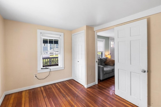 134 Hampton Cir, Hull, MA 02045 - unfurnished bedroom featuring baseboards, dark wood finished floors, and a closet