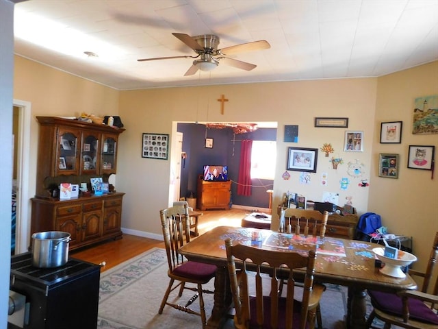 dining area with ceiling fan and hardwood / wood-style floors