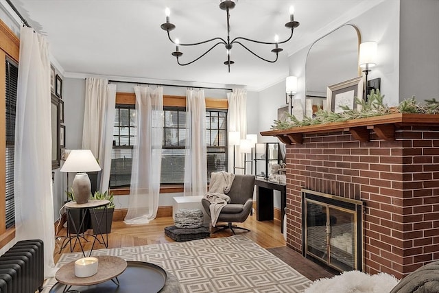 living area featuring crown molding, radiator heating unit, light hardwood / wood-style floors, and a brick fireplace