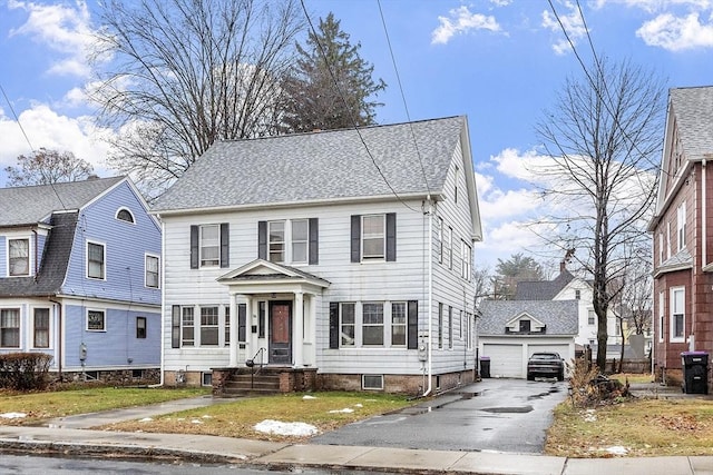 colonial-style house with a garage and an outdoor structure