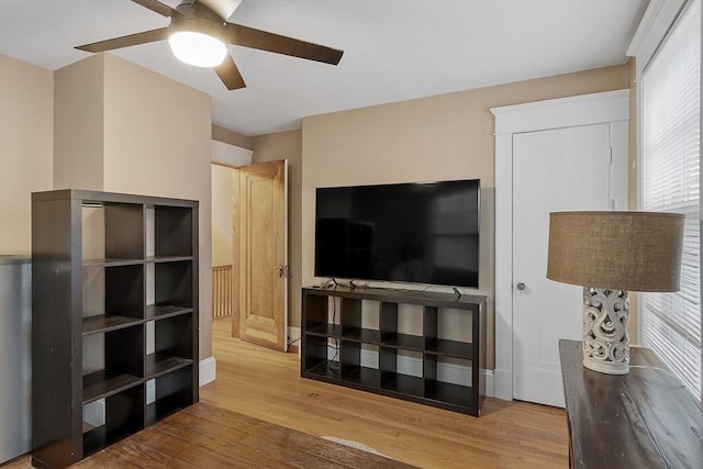 living room with ceiling fan and light hardwood / wood-style floors