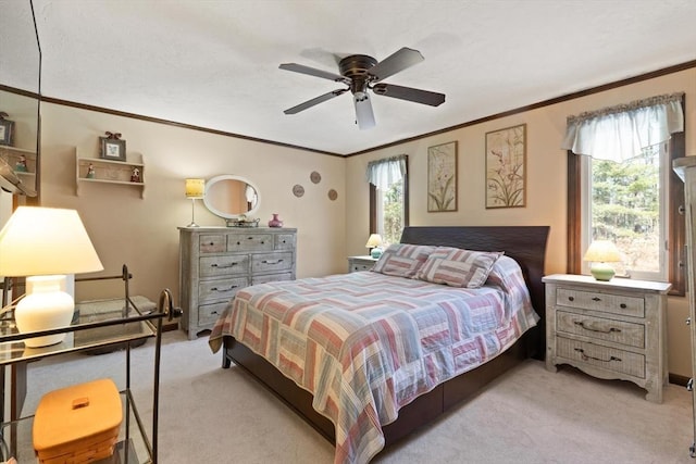 bedroom with multiple windows, ornamental molding, light colored carpet, and ceiling fan