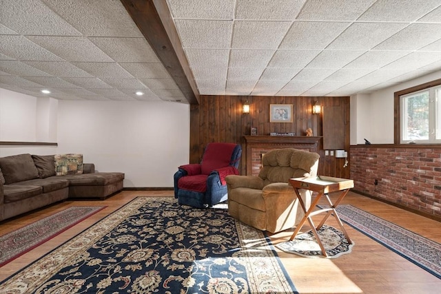 living room featuring hardwood / wood-style floors and wood walls