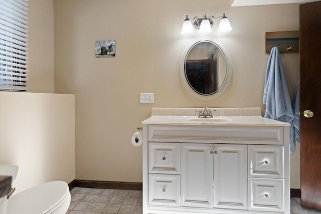 bathroom featuring vanity and toilet