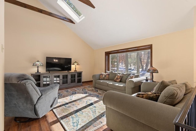 living room with wood-type flooring, a skylight, and high vaulted ceiling