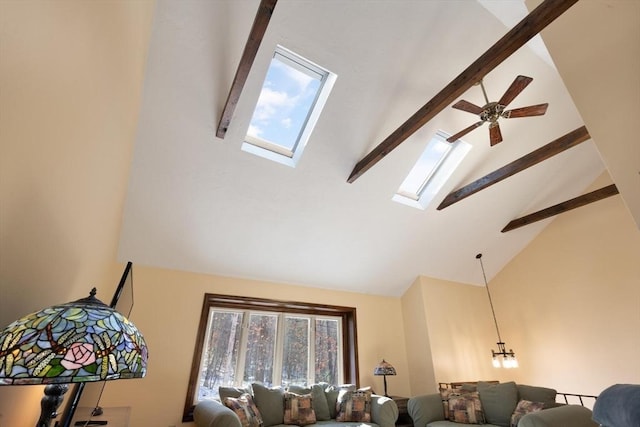 living room with beam ceiling, a skylight, high vaulted ceiling, and ceiling fan