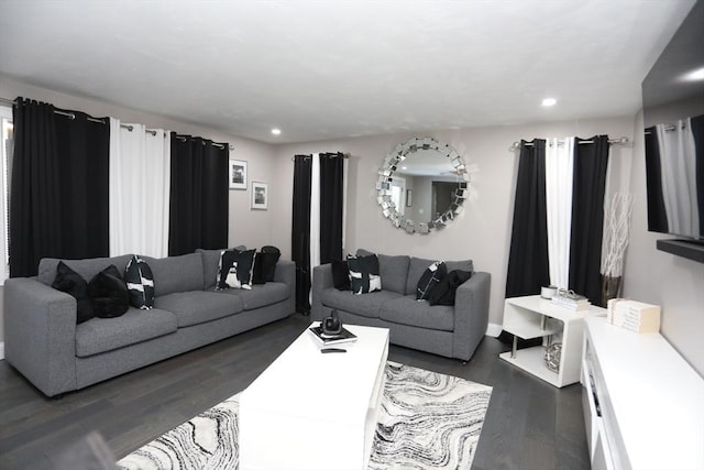 living area with dark wood-style floors and recessed lighting