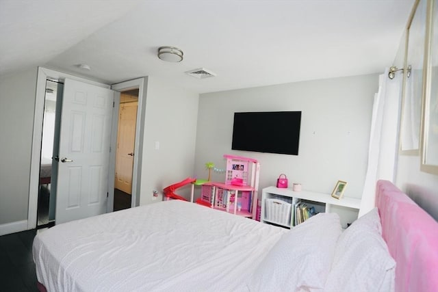 bedroom with wood finished floors and visible vents