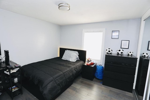 bedroom with dark wood-style floors