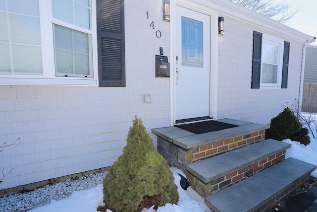 view of snow covered property entrance