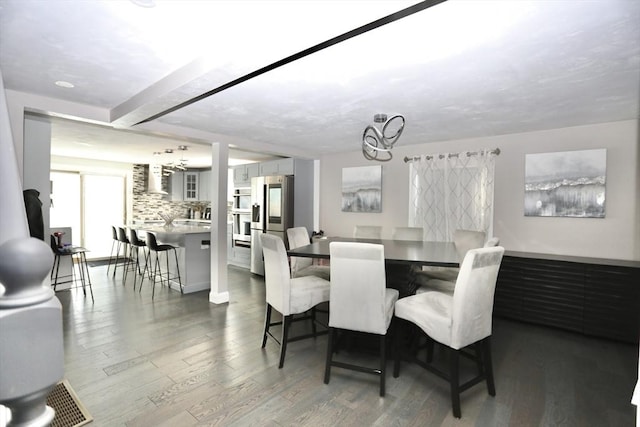 dining space with a chandelier and wood finished floors