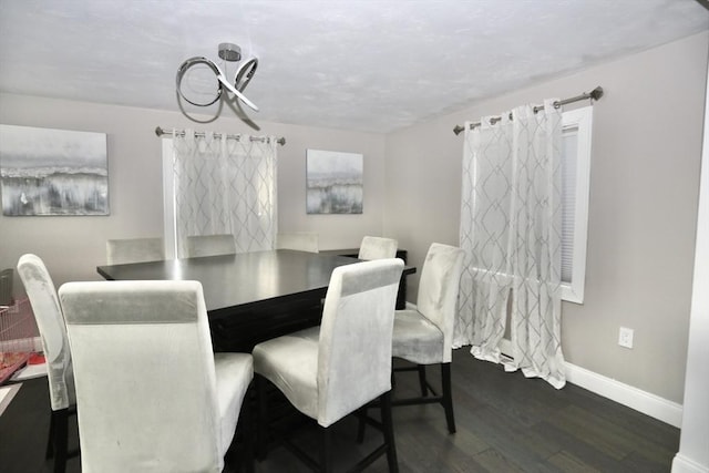 dining room featuring baseboards and dark wood-style flooring