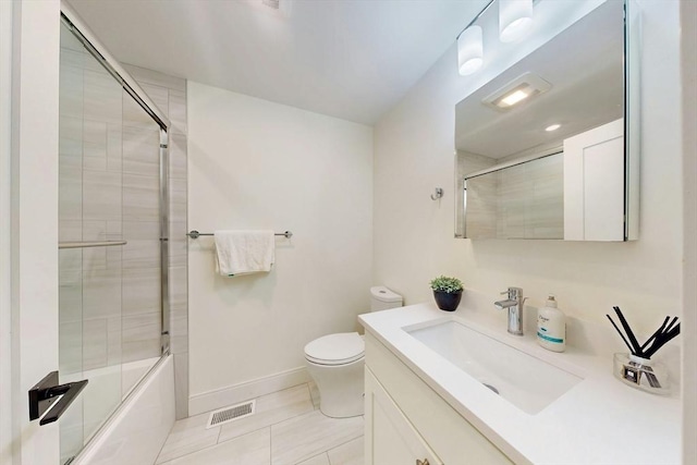 30 Pembroke St, Somerville, MA 02145 - bathroom featuring vanity, tile patterned floors, toilet, bath / shower combo with glass door, and baseboards