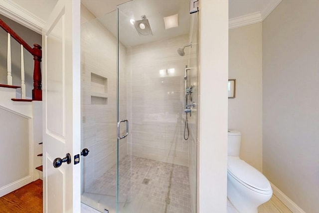 30 Pembroke St, Somerville, MA 02145 - bathroom with a stall shower, toilet, ornamental molding, and baseboards