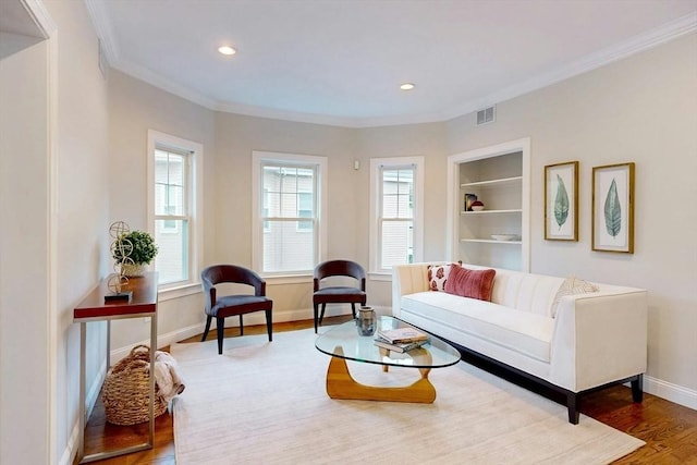 30 Pembroke St, Somerville, MA 02145 - living area with wood finished floors, ornamental molding, baseboards, built in shelves, and recessed lighting