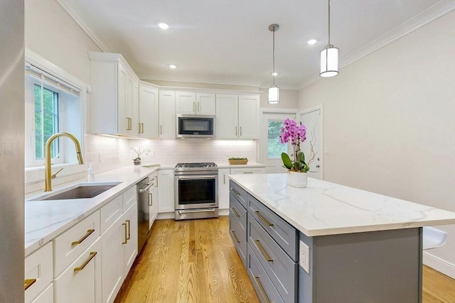 30 Pembroke St, Somerville, MA 02145 - kitchen with appliances with stainless steel finishes, gray cabinets, a sink, light wood finished floors, and crown molding