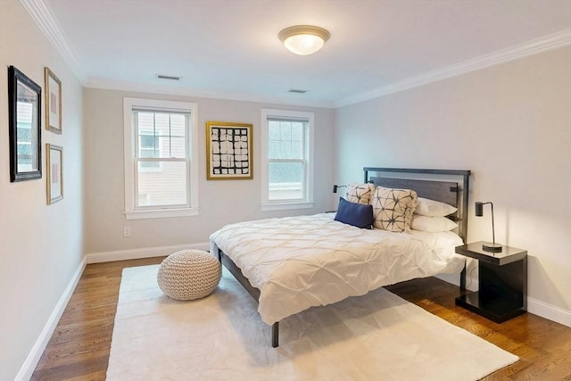 30 Pembroke St, Somerville, MA 02145 - bedroom featuring wood finished floors, multiple windows, crown molding, and baseboards
