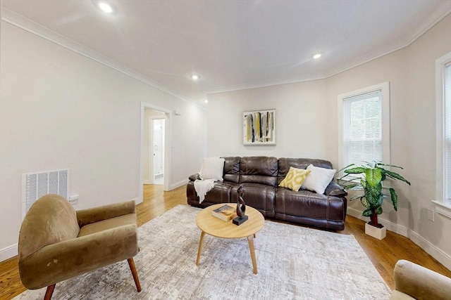 30 Pembroke St, Somerville, MA 02145 - living room with wood finished floors, baseboards, ornamental molding, and recessed lighting
