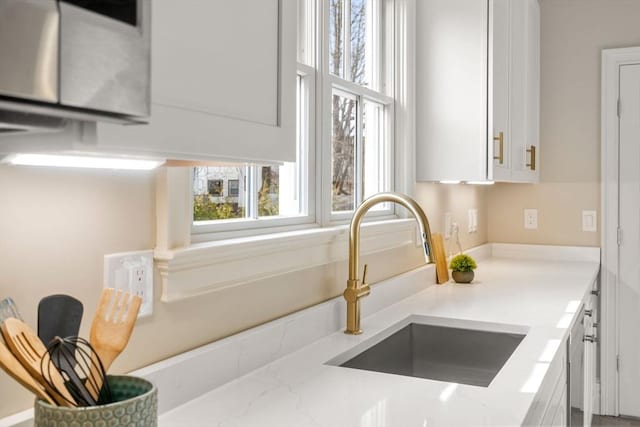 21 Francis St Unit 21, Newton, MA 02459 - kitchen view of a sink, white cabinets, and light stone counters