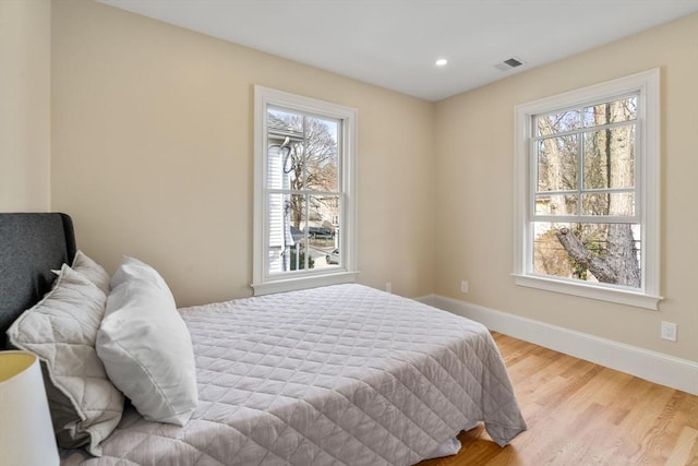 21 Francis St Unit 21, Newton, MA 02459 - bedroom with multiple windows, baseboards, wood finished floors, and recessed lighting
