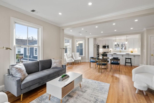 21 Francis St Unit 21, Newton, MA 02459 - living area featuring light wood-type flooring, crown molding, baseboards, and recessed lighting