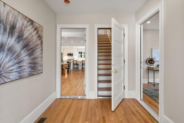 21 Francis St Unit 21, Newton, MA 02459 - hallway with light wood-style floors, stairs, baseboards, and recessed lighting