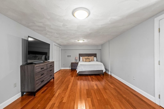 bedroom with wood finished floors and baseboards