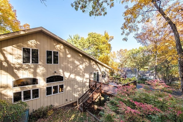 view of property exterior with a wooden deck