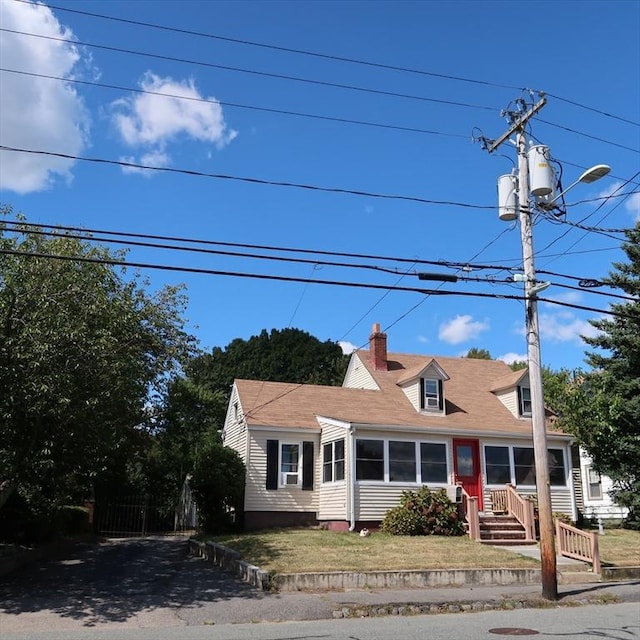 cape cod-style house featuring a chimney