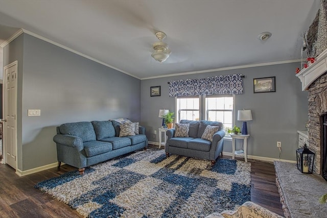 living room featuring dark hardwood / wood-style flooring, ornamental molding, ceiling fan, and a fireplace