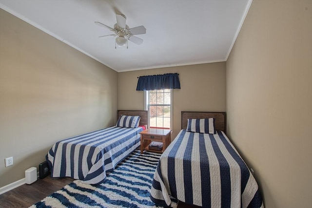 bedroom featuring dark wood-type flooring, ceiling fan, and ornamental molding