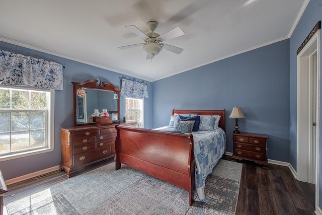 bedroom featuring dark wood-type flooring, ornamental molding, and ceiling fan