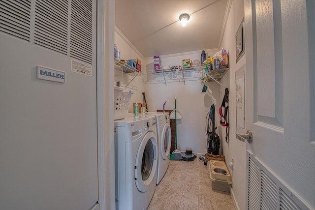 laundry room featuring crown molding and washing machine and dryer