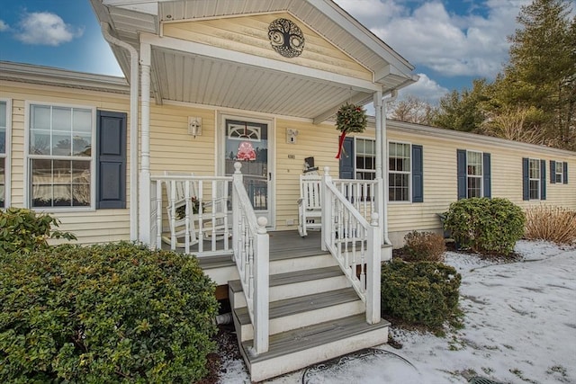 view of snow covered property entrance