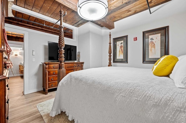 bedroom with beam ceiling, light wood-type flooring, and wooden ceiling
