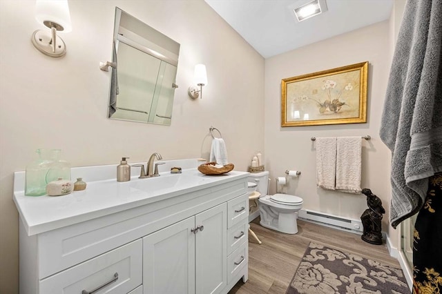 full bath with vanity, visible vents, baseboard heating, toilet, and wood finished floors