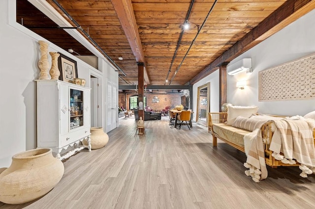 living area with track lighting, an AC wall unit, wood ceiling, beam ceiling, and wood finished floors