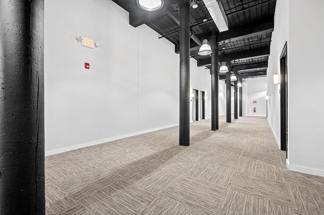 interior space featuring carpet and baseboards