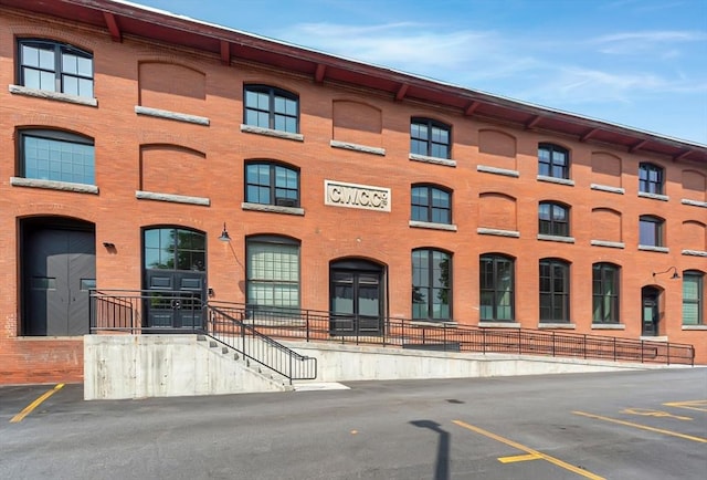 view of building exterior featuring uncovered parking