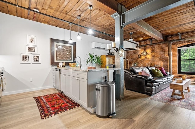 kitchen featuring light wood-style flooring, a wall mounted AC, wooden ceiling, a sink, and brick wall